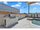 Outdoor grill with concrete counter, stainless steel grill and pristine pool at 8215 E Virginia Ave, Scottsdale, AZ 85257