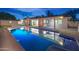 The backyard features a sparkling pool and multiple access points to the home at 8215 E Virginia Ave, Scottsdale, AZ 85257