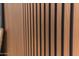 Close-up of a modern wall with beautiful wood slats, adding a touch of warmth and texture to the home's interior design at 8215 E Virginia Ave, Scottsdale, AZ 85257