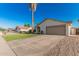 Home with well-kept lawn, desert landscaping, long driveway, and attached two-car garage at 8219 W Corrine Dr, Peoria, AZ 85381
