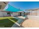 Beautiful backyard with artificial turf, shade cover, and desert landscaping at 1112 W Farmdale Ave, Mesa, AZ 85210