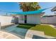 Backyard featuring artificial turf, shade cover, desert landscaping, and block wall at 1112 W Farmdale Ave, Mesa, AZ 85210