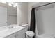 Clean bathroom featuring a shower with dark curtain, updated vanity, and modern fixtures at 1112 W Farmdale Ave, Mesa, AZ 85210