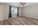 Cozy bedroom offers natural light and wood-look flooring for a warm and inviting feel at 1112 W Farmdale Ave, Mesa, AZ 85210