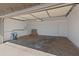 Large, empty garage with painted walls and an automatic garage door opener at 1112 W Farmdale Ave, Mesa, AZ 85210