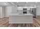 Modern kitchen featuring a large island, stainless steel appliances, and updated cabinets at 1112 W Farmdale Ave, Mesa, AZ 85210
