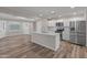 Bright kitchen features a large island, stainless steel appliances, and stylish white cabinetry at 1112 W Farmdale Ave, Mesa, AZ 85210