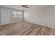 Bright living room with wood-look floors, ceiling fan and a large window at 1112 W Farmdale Ave, Mesa, AZ 85210