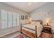 Neutral Primary bedroom featuring a wooden bed frame, wood floors, shuttered windows, and a cozy rug at 11224 E Carol Ave, Scottsdale, AZ 85259