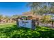 The beautiful Stonegate community clubhouse features a lawn, pond, and lush trees at 11224 E Carol Ave, Scottsdale, AZ 85259