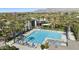 Large community pool with lounge chairs and umbrellas in a luxury 55+ active adult community at 11224 E Carol Ave, Scottsdale, AZ 85259