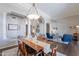 Spacious dining room with a large dining table, ornate chandelier, and open access to the living room at 11224 E Carol Ave, Scottsdale, AZ 85259