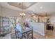 Dining area with a view of the outdoor pool and an open layout to the kitchen at 11224 E Carol Ave, Scottsdale, AZ 85259