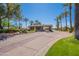 The gated entry into the beautiful Stonegate community is surrounded by lush trees and flowers at 11224 E Carol Ave, Scottsdale, AZ 85259