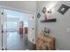 Inviting hallway with wood-look tile, decorative accents, and doorway to the living room at 11224 E Carol Ave, Scottsdale, AZ 85259