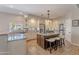 Bright kitchen with an island, stone countertops, stainless appliances, and travertine flooring at 11224 E Carol Ave, Scottsdale, AZ 85259