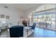 Bright living room with comfortable seating, a piano, and large sliding doors leading to the outdoor patio at 11224 E Carol Ave, Scottsdale, AZ 85259