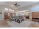 Spacious living room with a large sectional, vaulted ceilings, tile flooring and a view of the kitchen at 11224 E Carol Ave, Scottsdale, AZ 85259