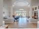 View from foyer into open-concept living room, dining room, and outdoor patio with furniture at 11224 E Carol Ave, Scottsdale, AZ 85259