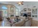 Spacious living room featuring fireplace, built-in shelving, and comfortable sectional sofa at 11224 E Carol Ave, Scottsdale, AZ 85259