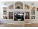 Close up of the living room built-in shelving and entertainment center with a large television at 11224 E Carol Ave, Scottsdale, AZ 85259