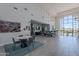Large community meeting room with seating, plants, artwork, and a scenic outdoor view at 11224 E Carol Ave, Scottsdale, AZ 85259