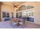 Outdoor patio featuring a dining table, seating, ceiling fan, and view of the pool and backyard at 11224 E Carol Ave, Scottsdale, AZ 85259