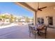 Covered patio featuring a dining table and chairs with a view of the backyard and pool at 11224 E Carol Ave, Scottsdale, AZ 85259