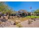 The beautiful Stonegate community center features a pond with rock features at 11224 E Carol Ave, Scottsdale, AZ 85259