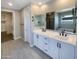 Modern bathroom features double sinks, white cabinetry, a soaking tub and a shower at 11663 W Luxton Ln, Avondale, AZ 85323