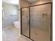 Bathroom featuring luxurious frameless shower, soaking tub, and tiled walls at 11663 W Luxton Ln, Avondale, AZ 85323
