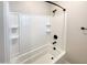 Clean bathtub with white tile surround and modern black fixtures at 11663 W Luxton Ln, Avondale, AZ 85323