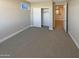 Bedroom with closet, carpet, neutral paint, and sunny windows at 11663 W Luxton Ln, Avondale, AZ 85323