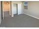 Bright bedroom with neutral carpet, closet, and natural light from a window at 11663 W Luxton Ln, Avondale, AZ 85323