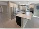 Modern kitchen featuring stainless steel appliances, a center island, and white cabinets at 11663 W Luxton Ln, Avondale, AZ 85323