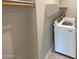 Laundry room with white washer and dryer and plenty of storage space at 11663 W Luxton Ln, Avondale, AZ 85323