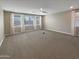 Large living area features carpet, recessed lighting, and bright windows with blinds and drapes at 11663 W Luxton Ln, Avondale, AZ 85323