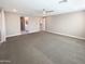 Spacious living room with open doorway leading to bathroom and kitchen at 11663 W Luxton Ln, Avondale, AZ 85323