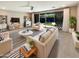 Bright living room with modern furnishings, stylish decor, and sliding door to the backyard pool at 11663 W Luxton Ln, Avondale, AZ 85323