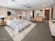 Spacious main bedroom with a ceiling fan, soft carpet, and neutral decor at 11663 W Luxton Ln, Avondale, AZ 85323