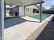 Covered outdoor patio area overlooking a modern pool and backyard at 11663 W Luxton Ln, Avondale, AZ 85323