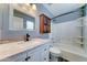 Nicely appointed bathroom with granite countertop vanity and a tub with white tile surround at 15454 W Evans Dr, Surprise, AZ 85379