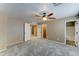 Neutral primary bedroom featuring plush carpet, ceiling fan, and ensuite bathroom at 15454 W Evans Dr, Surprise, AZ 85379