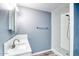 Updated bathroom with tiled shower, modern vanity and fixtures; bright and airy at 1556 E Dover Cir, Mesa, AZ 85203