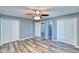 Spacious bedroom with two closets, neutral paint, modern ceiling fan and stylish flooring at 1556 E Dover Cir, Mesa, AZ 85203