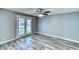 Light-filled bedroom with luxury vinyl plank flooring and french doors that open to the backyard at 1556 E Dover Cir, Mesa, AZ 85203