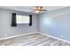 Comfortable bedroom with neutral paint, natural light, and luxury vinyl plank flooring at 1556 E Dover Cir, Mesa, AZ 85203