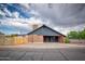 Modern single-story home with attached carport, brick accents, and unique architectural design at 1556 E Dover Cir, Mesa, AZ 85203