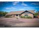 Charming single-story brick home featuring a well-maintained yard with mature landscaping at 1556 E Dover Cir, Mesa, AZ 85203