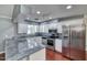 Modern kitchen features stainless steel appliances, granite countertops, and white cabinetry at 1556 E Dover Cir, Mesa, AZ 85203